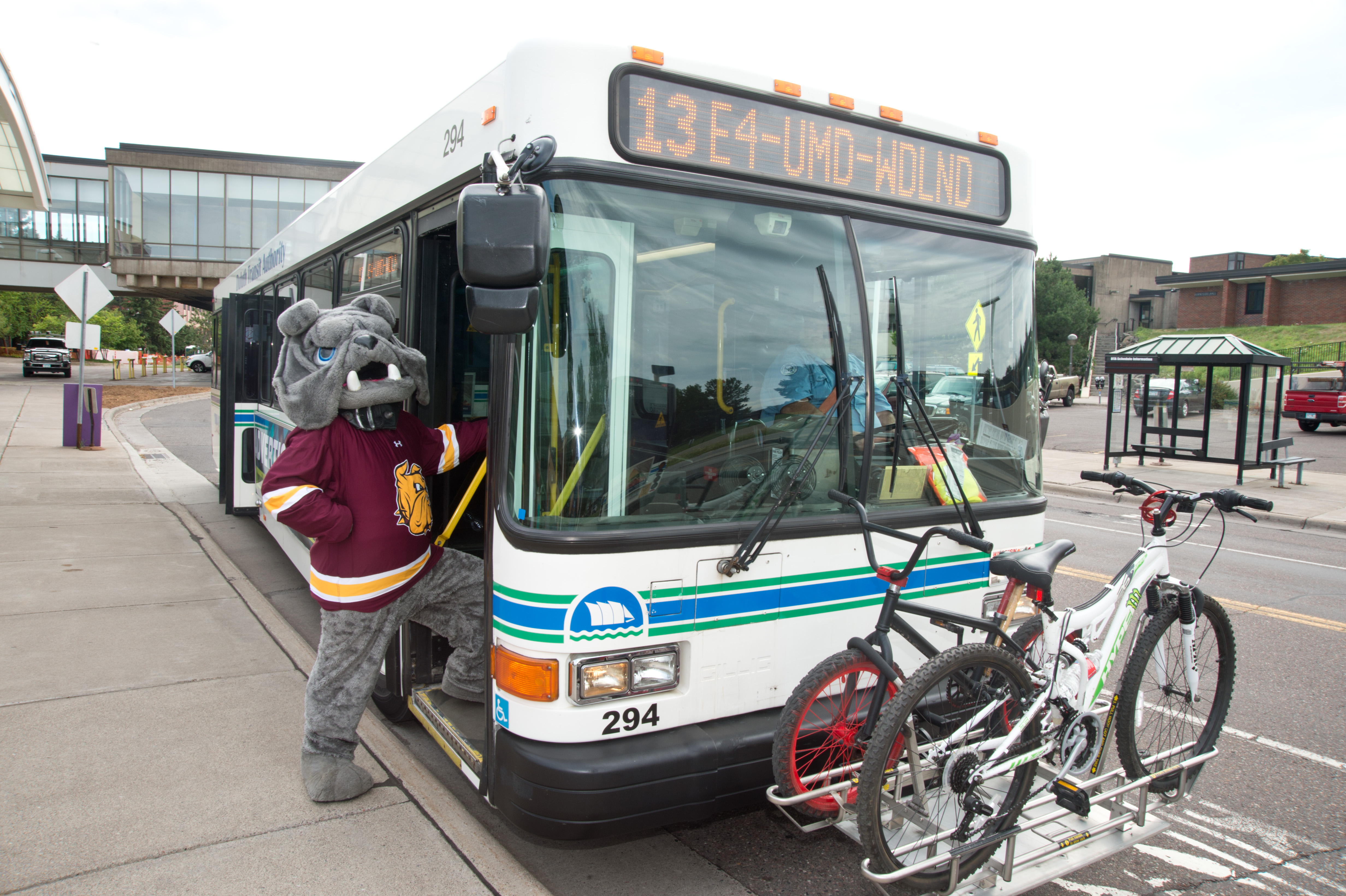 Champ the Bulldog posing next to a DTA bus